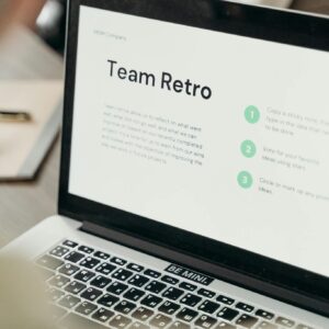 Close-up of a laptop screen displaying team collaboration discussing a business project.