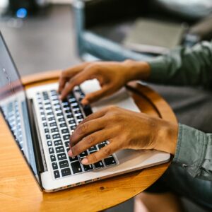 Focused work with hands typing on a laptop, capturing productivity and technology.