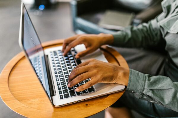 Focused work with hands typing on a laptop, capturing productivity and technology.